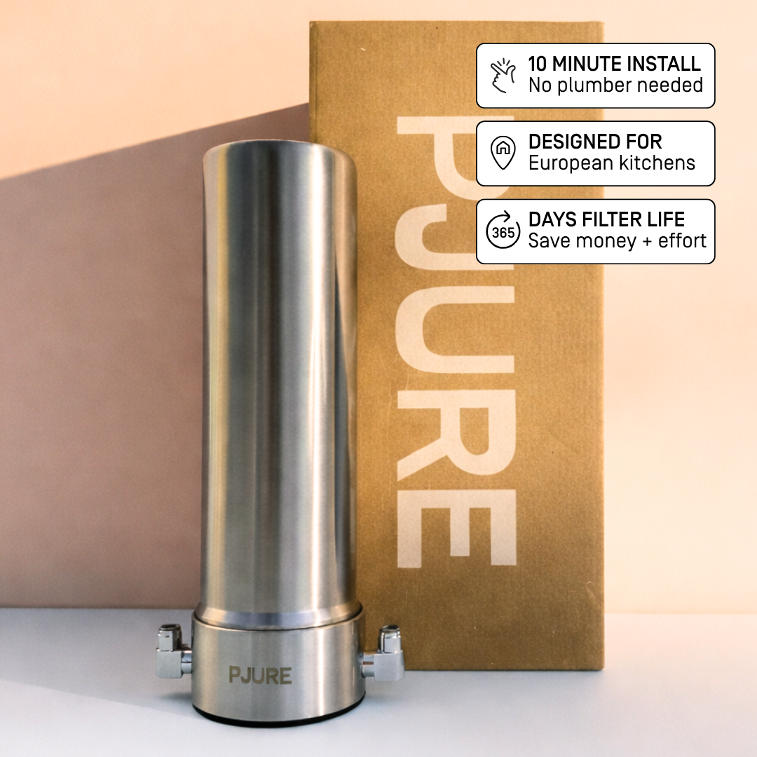 PJURE stainless steel under-sink water filter with kraft paper packaging — features 10-minute install, designed for European kitchens, 365-day filter life